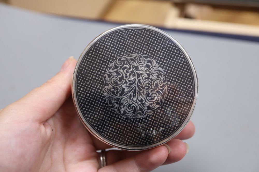 A 20th century Persian white metal and niello circular box and cover, 8cm, gross 3oz.